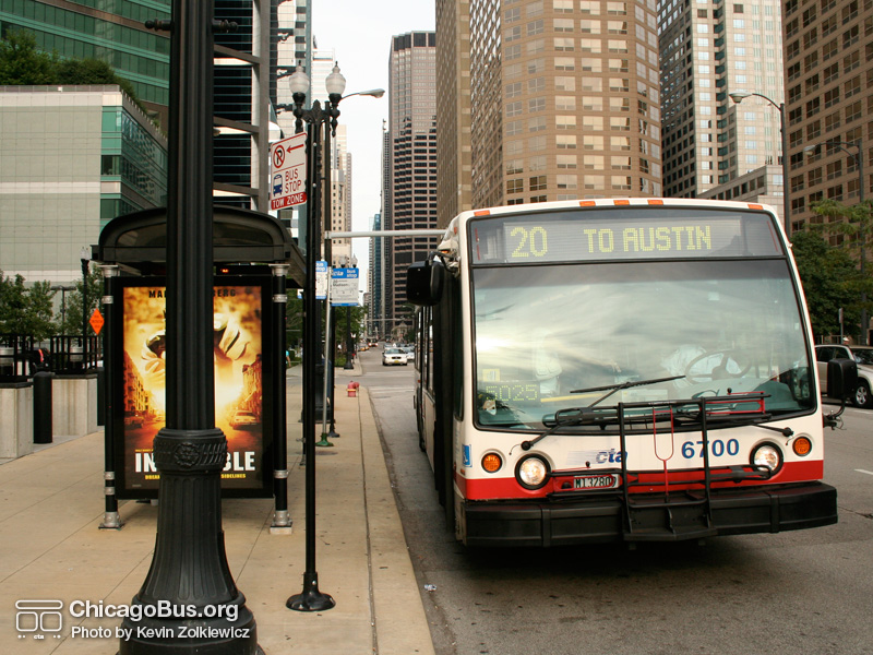 Click to advance to next image. Bus #6700 at Madison and Jefferson working route #20 Madison on August 5, 2006. As part of the Bus Tracker pilot, the bus shelter at this location contains an LED sign which displays estimated arrival times along with the current time and temperature. (Photo by Kevin Zolkiewicz)